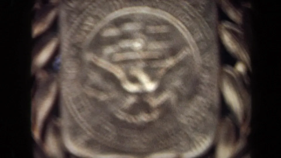 1970 Washington, DC frame at the end of the zoom, tightly focused on the emblem's central raised symbol and text ring.