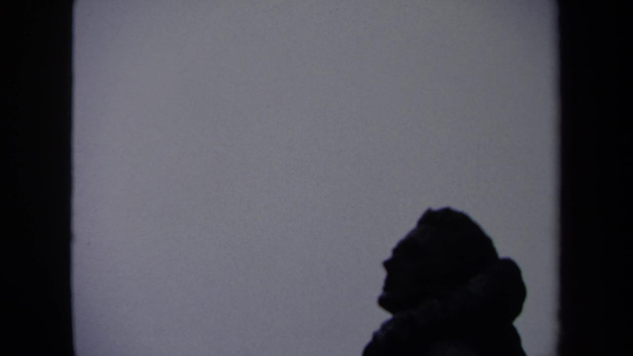 A dark side-profile silhouette remains visible near a wall edge in this 1970 Washington, DC home-movie frame.