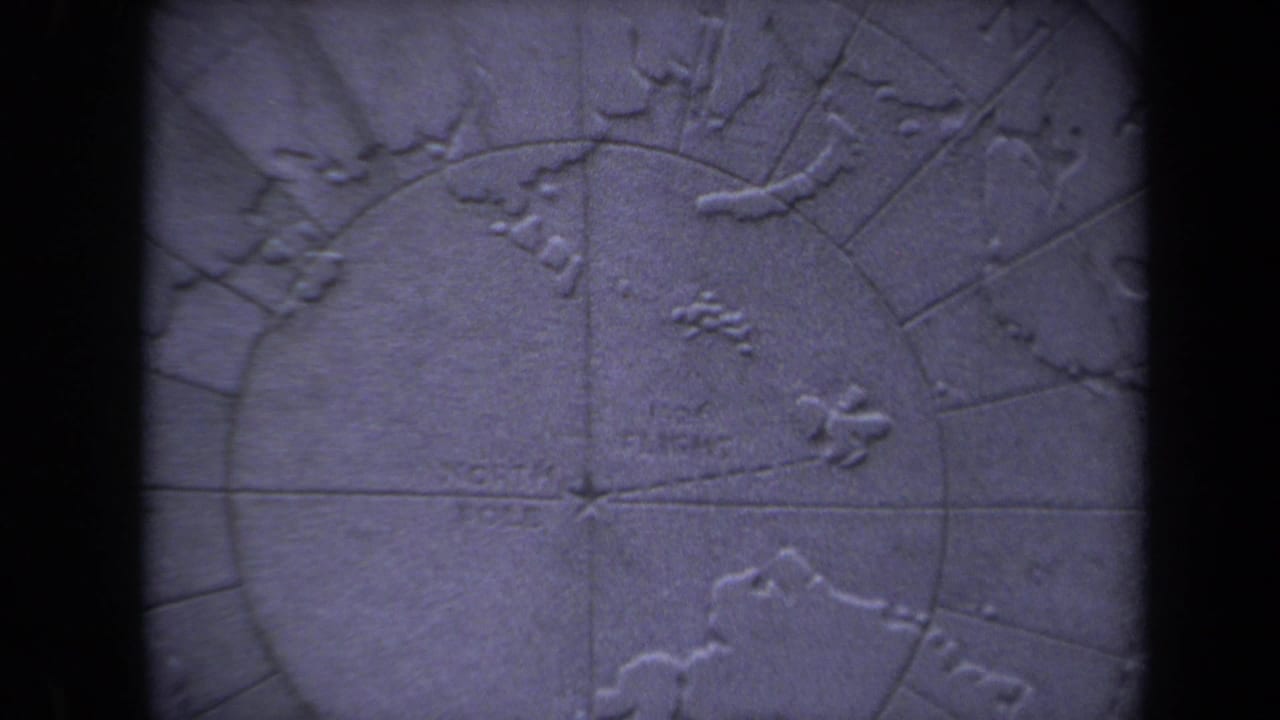 1970 8mm frame from Washington, DC showing a blue-purple raised relief map centered near the North Pole area.