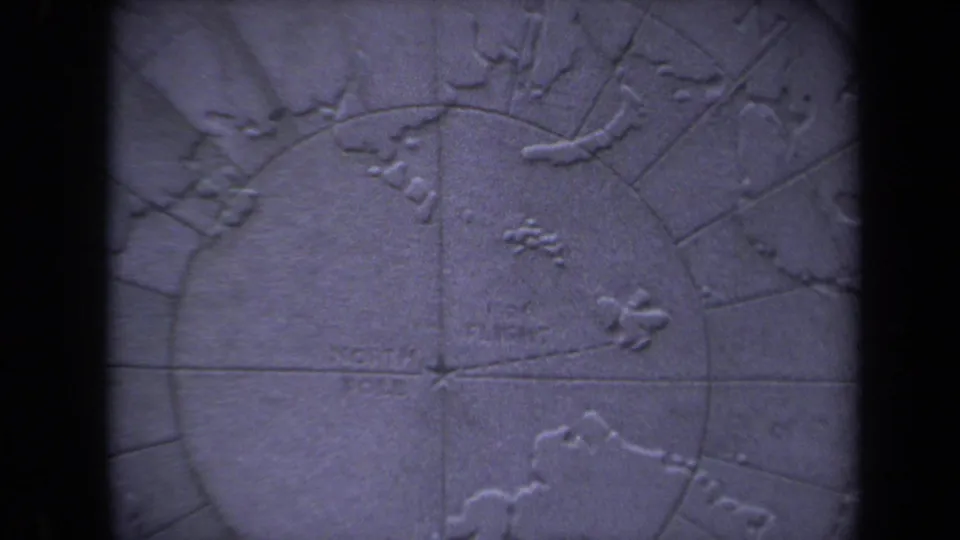 1970 8mm frame from Washington, DC showing a blue-purple raised relief map centered near the North Pole area.