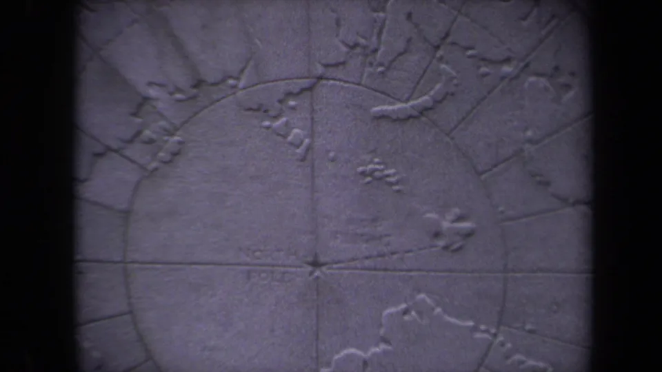 Soft 8mm close-up of the polar map surface, showing raised landforms and circular guide lines in the 1970 Washington, DC clip.