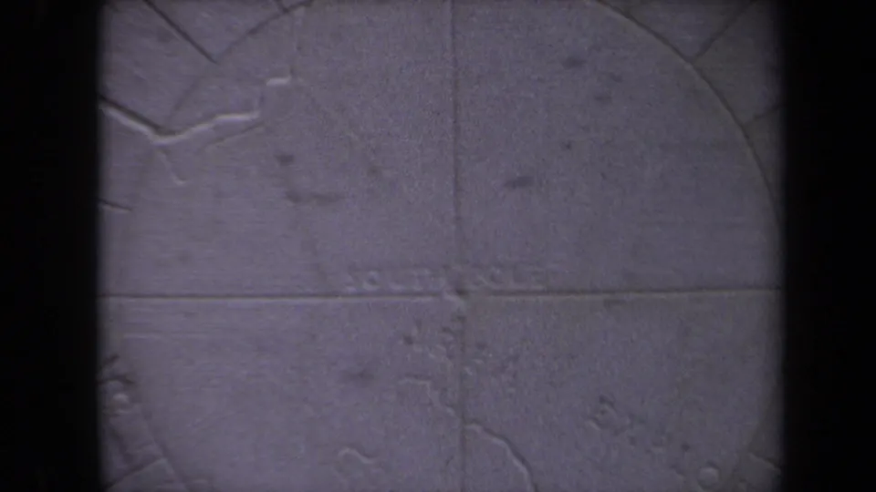 Close 8mm view of a carved polar map detail in Washington, DC, with South Pole text faintly visible on weathered stone.