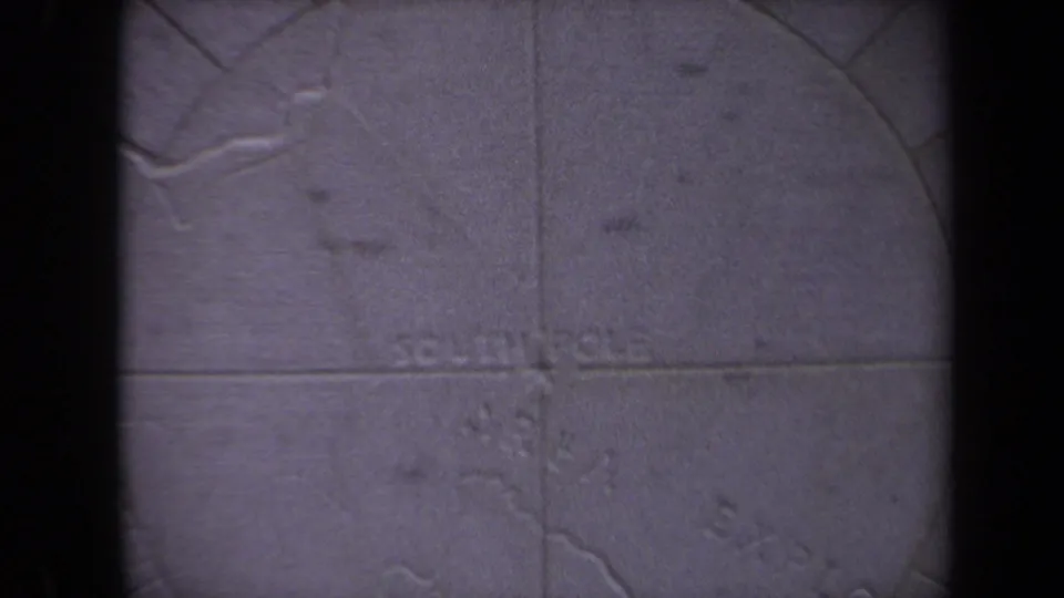 1970 Washington, DC frame showing the lower part of a weathered carved map stone, partly obscured by dark vertical bars.