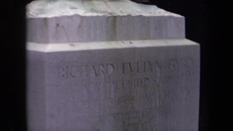 Washington, DC 1970 home-movie frame showing a stepped stone marker with partial inscription text and adjacent carved stone map surface.