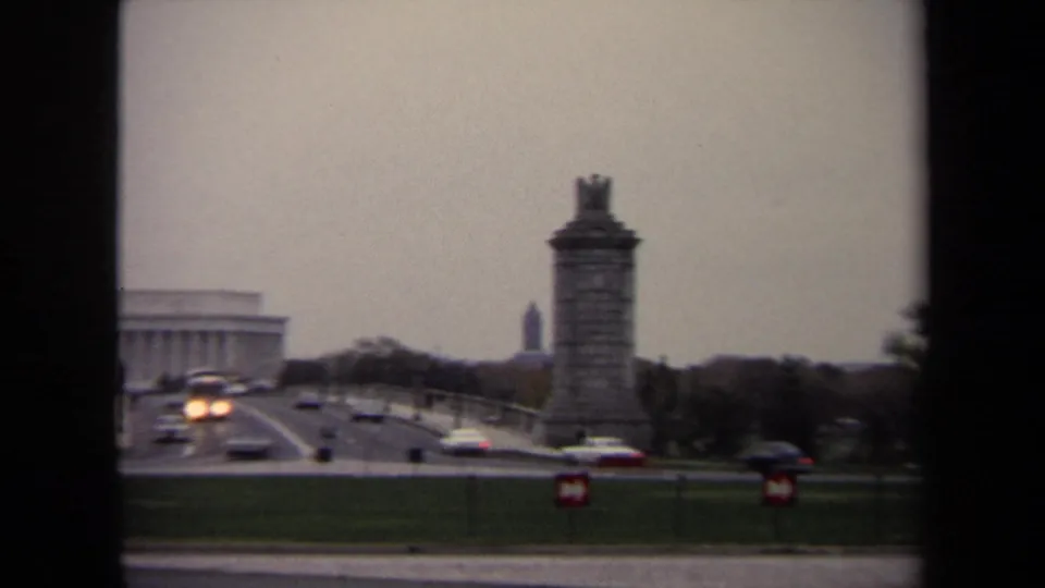 1970 Washington, DC view toward the Lincoln Memorial and Arlington Memorial Bridge, with cars moving through the monumental landscape.