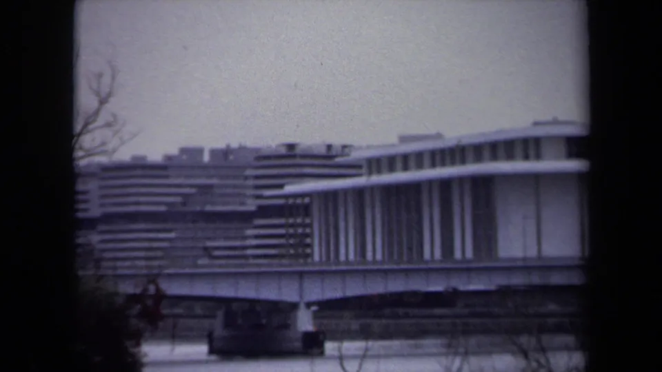 Final 1970 Washington, DC frame tightly crops the bridge or overpass and adjacent modernist facade across the river.