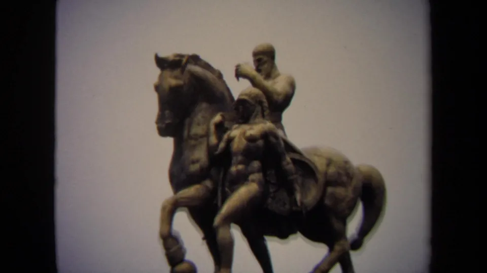 Washington, DC 1970 home-movie frame showing a bronze horse with a rider and female figure, filmed from a slightly wider side angle.