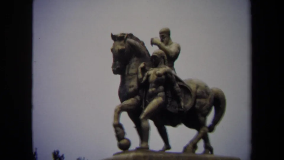 Close 1970 8mm view of an equestrian statue in Washington DC, with the rider and horse silhouetted against an overcast sky.