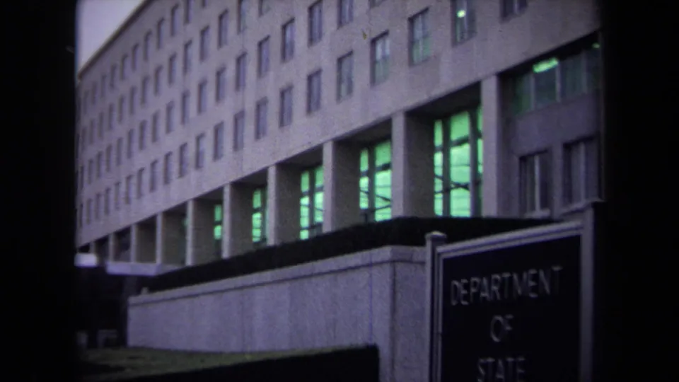 1970 Washington, DC Department of State exterior with the building facade behind a foreground sign identifying the department.