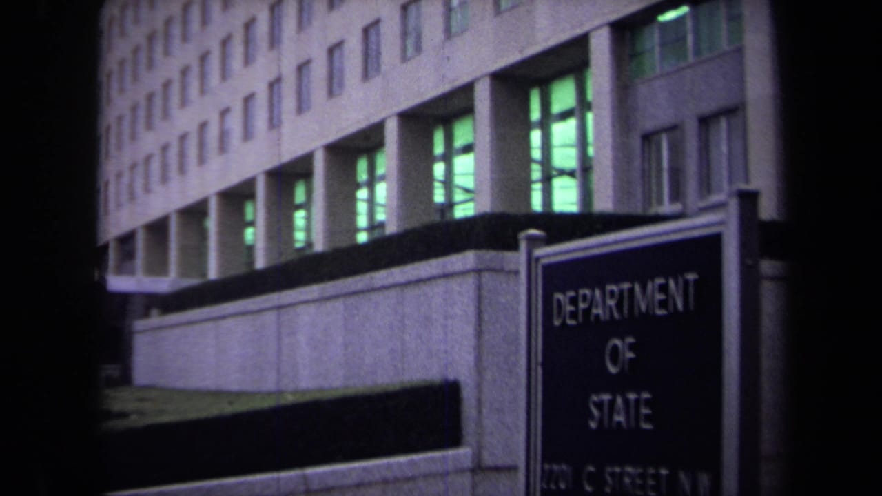 Washington, DC Department of State sign and modernist office facade seen in grainy 1970 8mm footage.