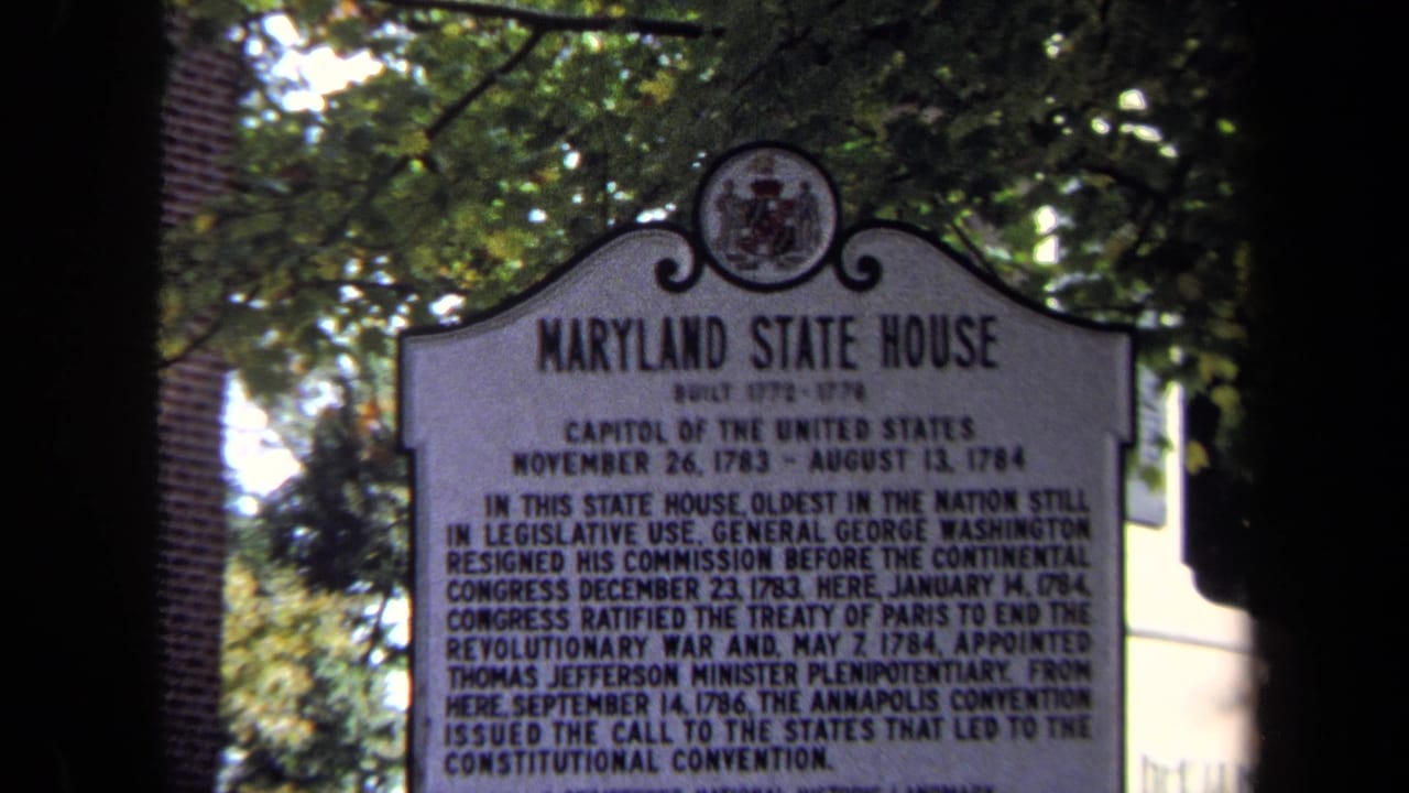 The marker fills the frame, with readable Maryland State House heading, leafy branches above, and dark film-edge shadowing.