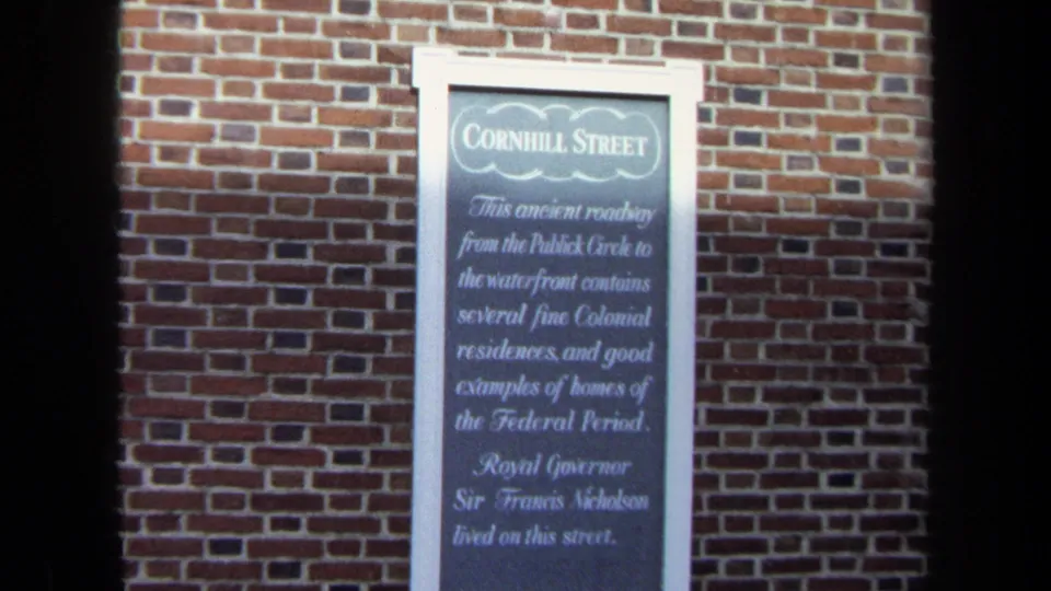 1970 Washington, DC 8mm frame showing a Cornhill Street historical marker mounted on a red brick wall.
