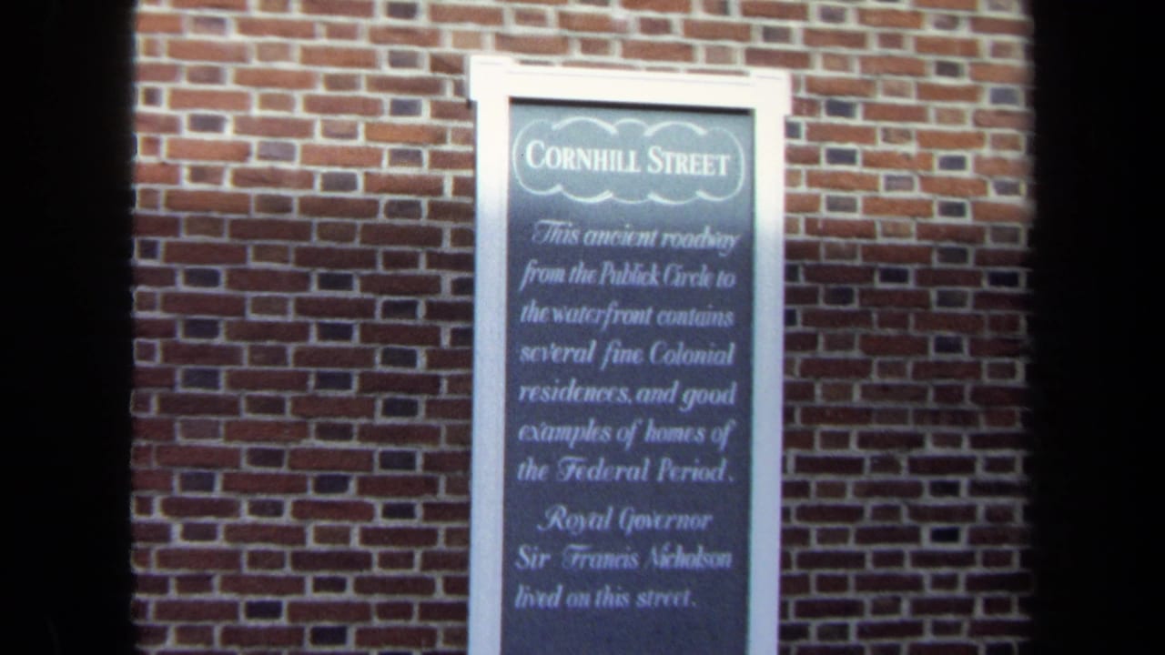 Cornhill Street historical marker on a red brick wall in Washington, DC, seen in soft 8mm color.