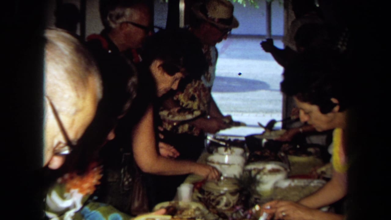 Guests serve themselves from bowls and pots on a long table.