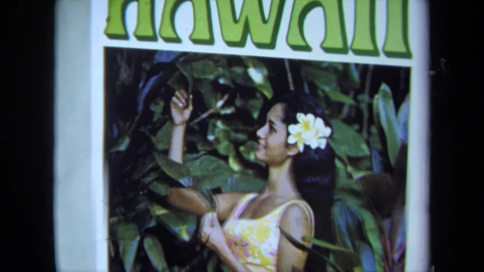 Magazine cover with large green Hawaii lettering above the same posed woman in foliage, filmed on 8mm in the 1971 clip.