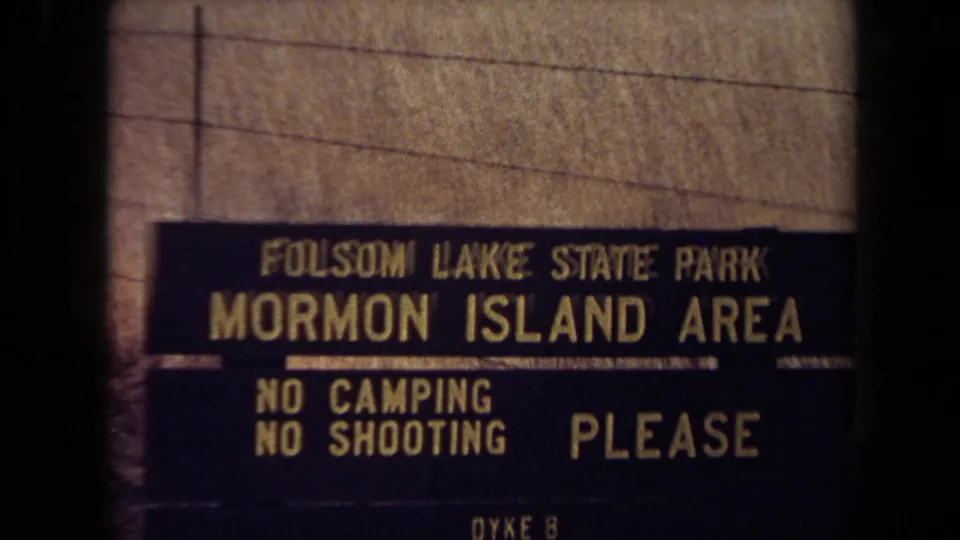 Close view of the Folsom Lake State Park Mormon Island Area sign, with posted rules including no camping and no shooting.