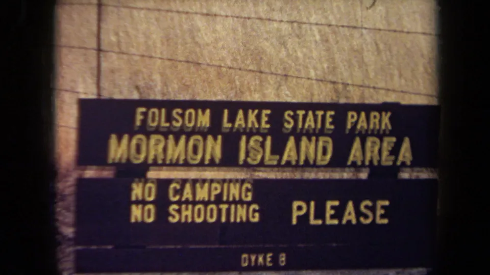 Closer 1971 frame of the Folsom Lake State Park Mormon Island Area sign, showing visitor rules and Dyke 8 text.