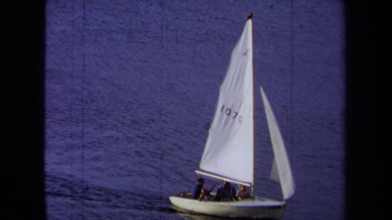 1971 California 8mm frame showing a small white sailboat with sail number 1070 moving across blue water.