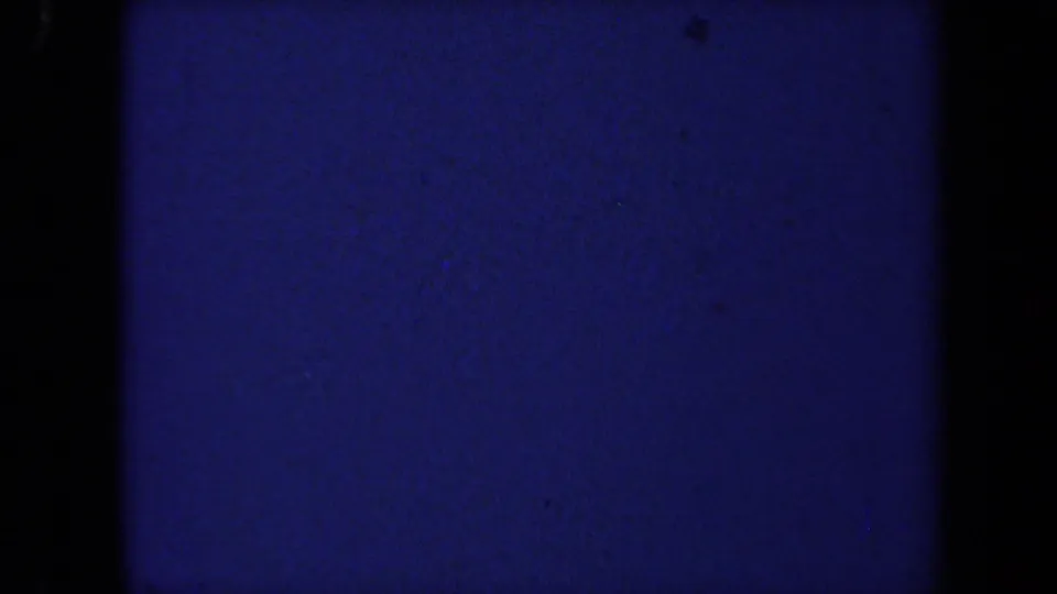 Blue-toned 8mm transitional frame from the 1971 California home movie, with grain and edge shadows visible.