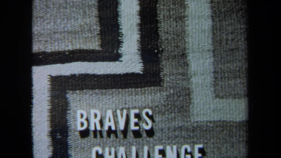 1971 California 8mm title-card frame with “BRAVES” and partial “CHALLENGE” lettering on a textured geometric background.