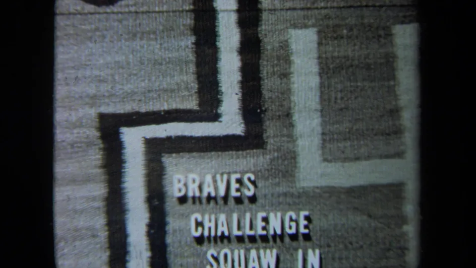 1971 California 8mm title-card frame showing “BRAVES CHALLENGE” and partial “SQUAW IN” text on a textured geometric design.