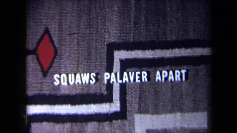 8mm frame showing a title card with the words SQUAWS PALAVER APART over or near a patterned textile surface.