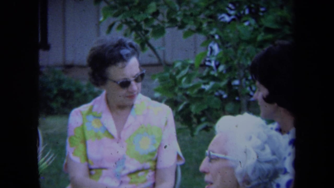 Older women continue talking outside in the supported 1971 California home-movie setting, framed through soft 8mm focus.