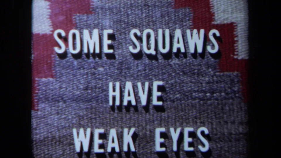 The 8mm frame shows a close view of a textured title card with the same offensive wording in white raised letters.