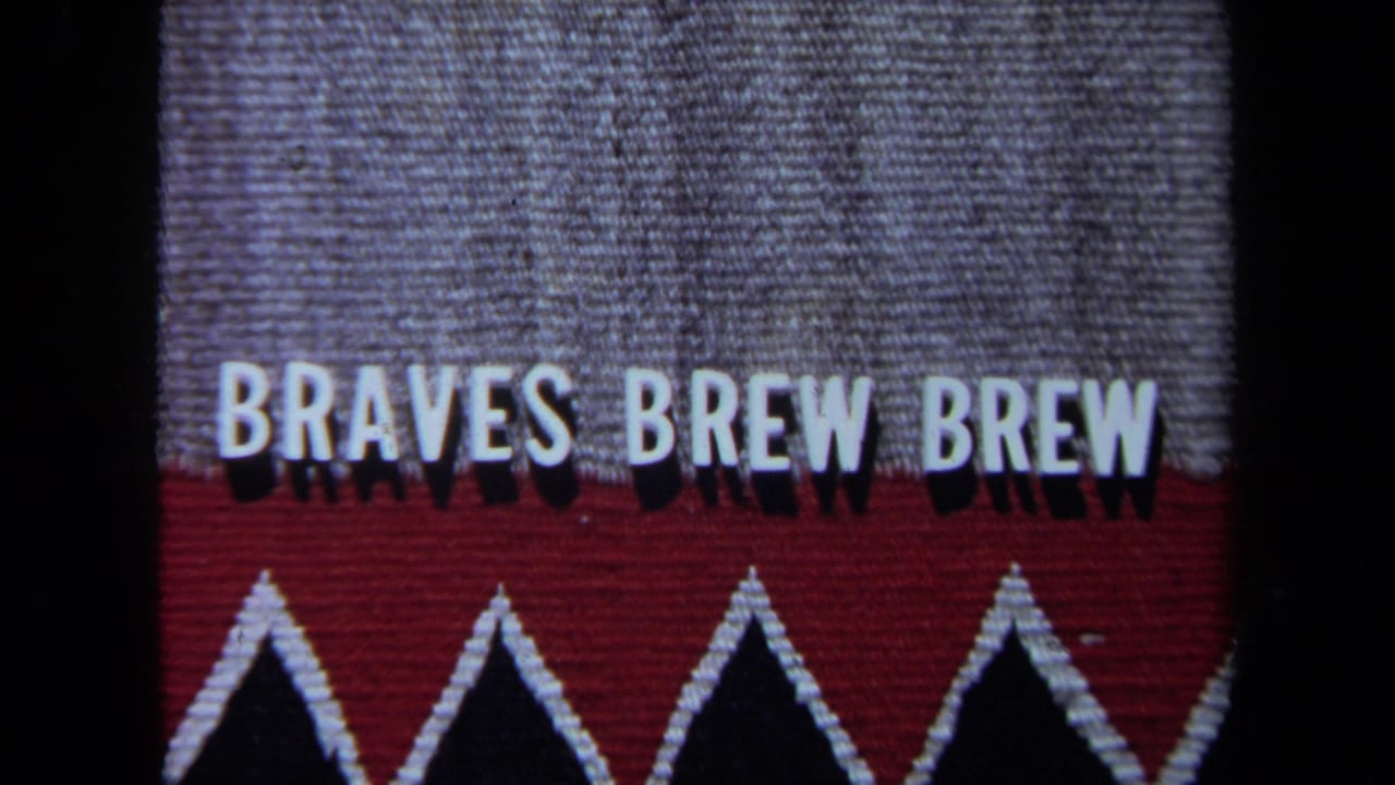 Close view of a red and gray sign with white letters reading BRAVES BREW BREW.