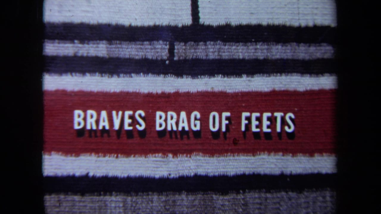 Red banner with white text reading BRAVES BRAG OF FEETS on a striped background.
