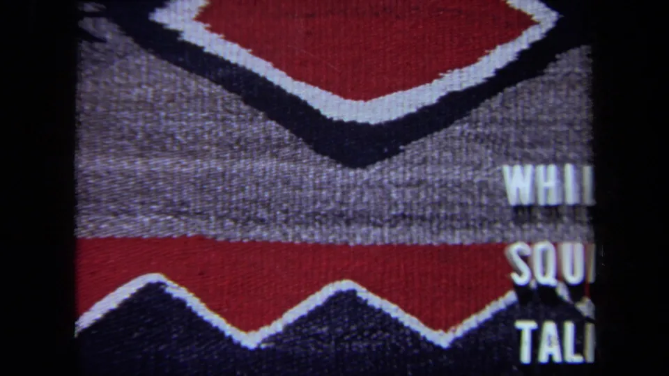 1971 California 8mm frame with the phrase mostly sliding out of view at the right edge over the same geometric fabric pattern.