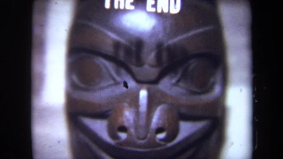 1971 California 8mm frame showing a soft close-up of a carved mask beneath partial THE END title text.