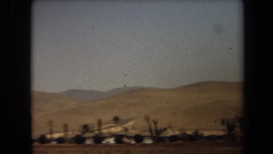 1971 Laguna Hills 8mm frame with dry rolling hills, low vegetation, and motion-softened roadside detail.