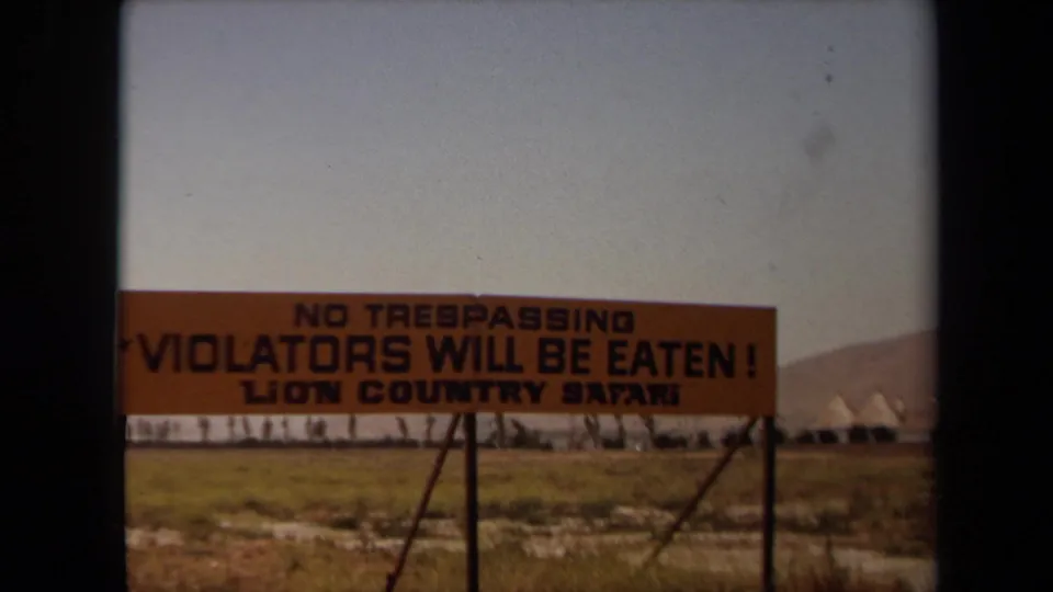 1971 Laguna Hills footage showing an orange Lion Country Safari warning sign reading that trespassers will be eaten.