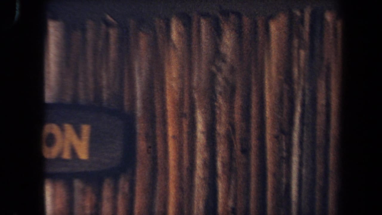 Wood-sided structure with a partially visible sign showing the letters ON.