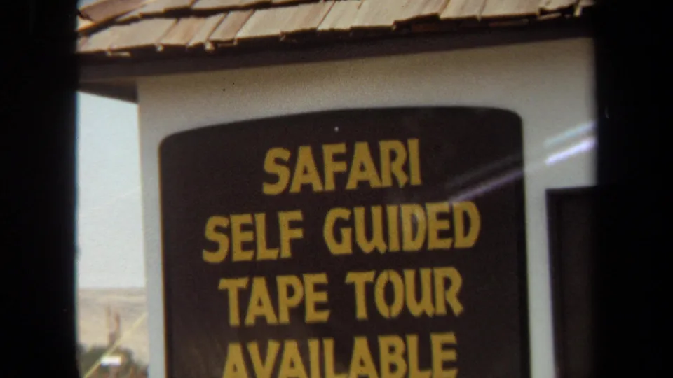 The 1971 Laguna Hills footage holds on a black-and-yellow Safari Self Guided Tape Tour Available sign.