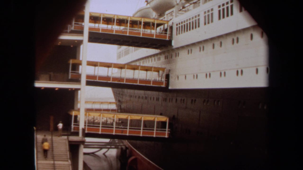 1971 Long Beach home-movie view of passengers boarding a large ship across multiple covered gangway levels.