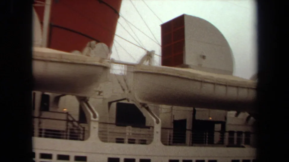 1971 Long Beach view of the liner's side with a suspended lifeboat, davits, railings, radar dome, and partial red funnel.