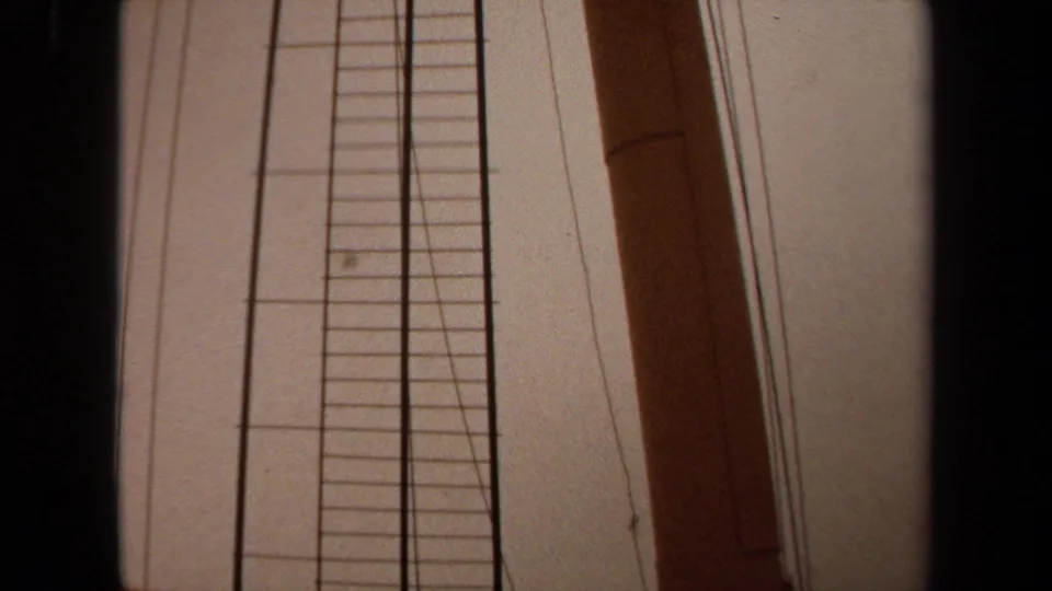 1971 Long Beach 8mm frame showing a low-angle boat-side detail with a vertical ladder, wooden mast, rigging lines, and pale sky.