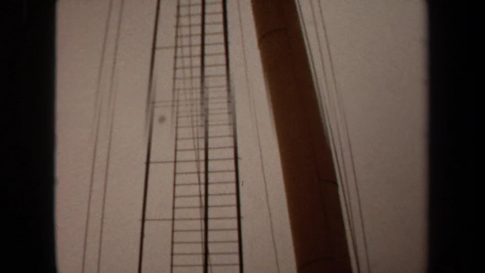 1971 Long Beach 8mm frame showing a close low-angle view of boat ladder rails, mast, rigging wires, and faded sky.