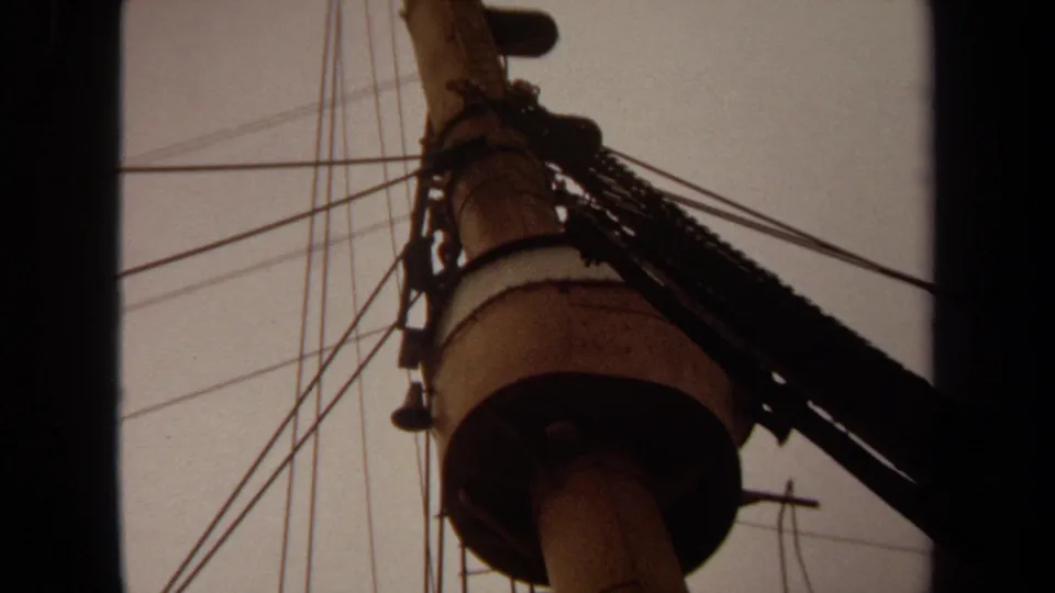 1971 Long Beach 8mm frame with the pole and circular hardware near center, crossed by wires and a heavy dark cable.