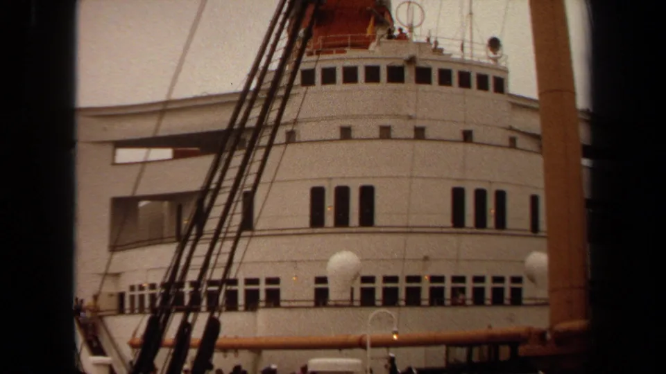 1971 Long Beach frame showing the ship's white exterior, multiple window rows, deck railings, and rigging from a dockside angle.