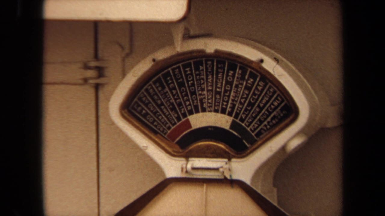 1971 Long Beach home-movie frame showing a ship deck scale with printed instructions on its dial.