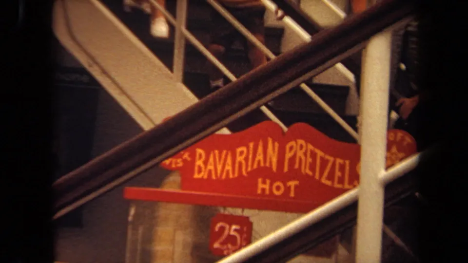 Ship deck cutaway showing a red hot Bavarian pretzels sign with a 25-cent marker beneath railings.
