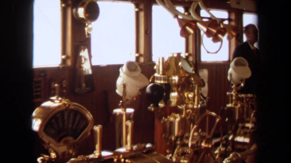 A wider 1971 Long Beach bridge view shows brass controls and instruments with a crew member in a dark suit near the windows.