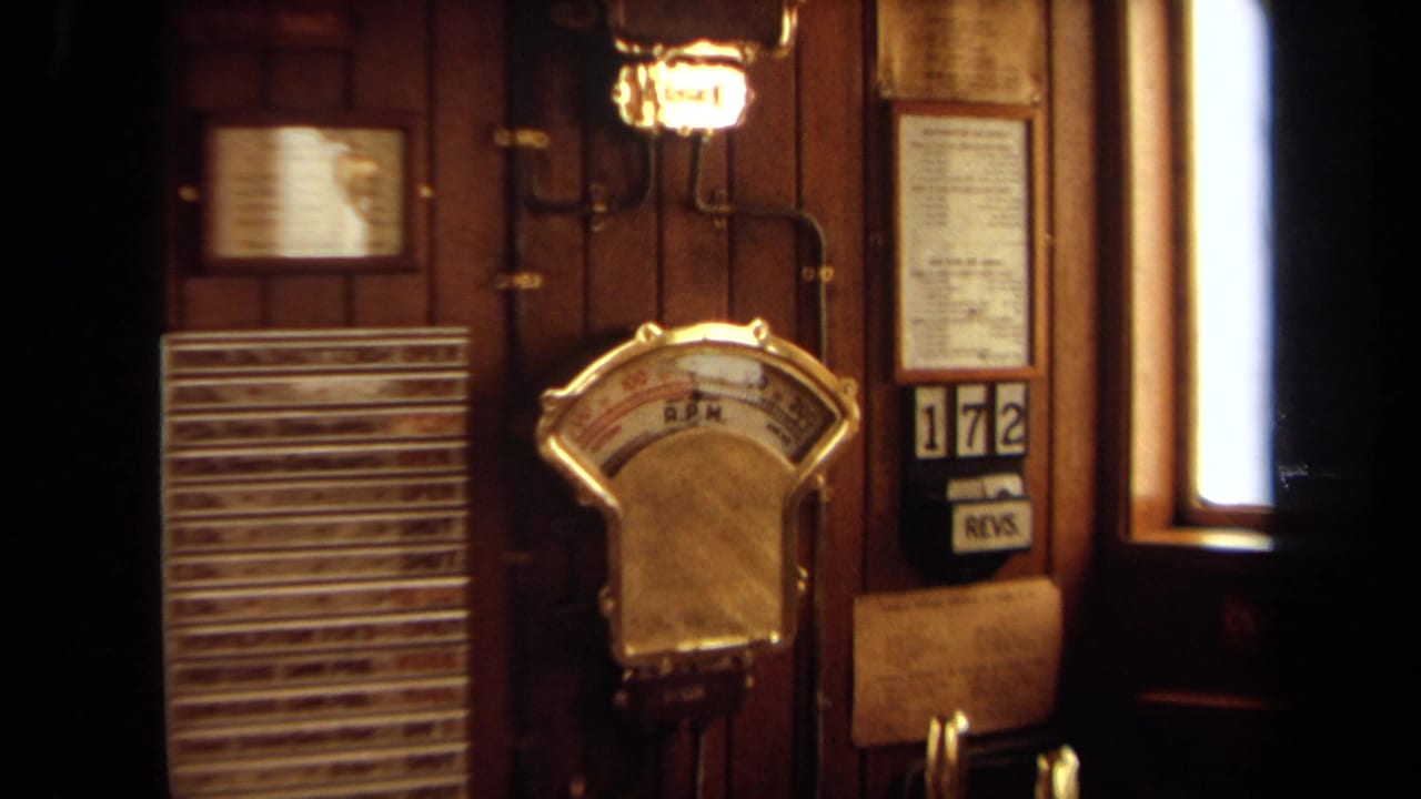 1971 8mm home-movie frame from Long Beach showing a brass-toned R.P.M. gauge on a wooden control panel.