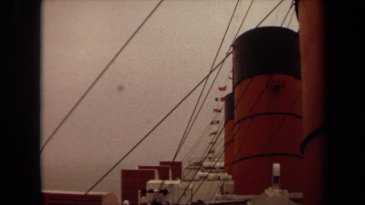 1971 Long Beach home-movie frame showing a red-and-black ship funnel, rigging, and deck details in soft 8mm color.