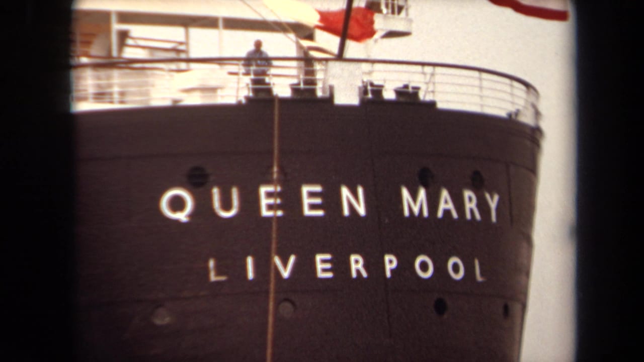 1971 Long Beach 8mm frame showing the Queen Mary bow, white Liverpool lettering, upper deck railings, and a small figure above.