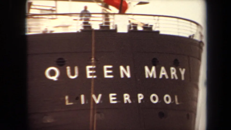 1971 Long Beach view of the Queen Mary name and Liverpool lettering on the hull, with deck railings and a small person above.