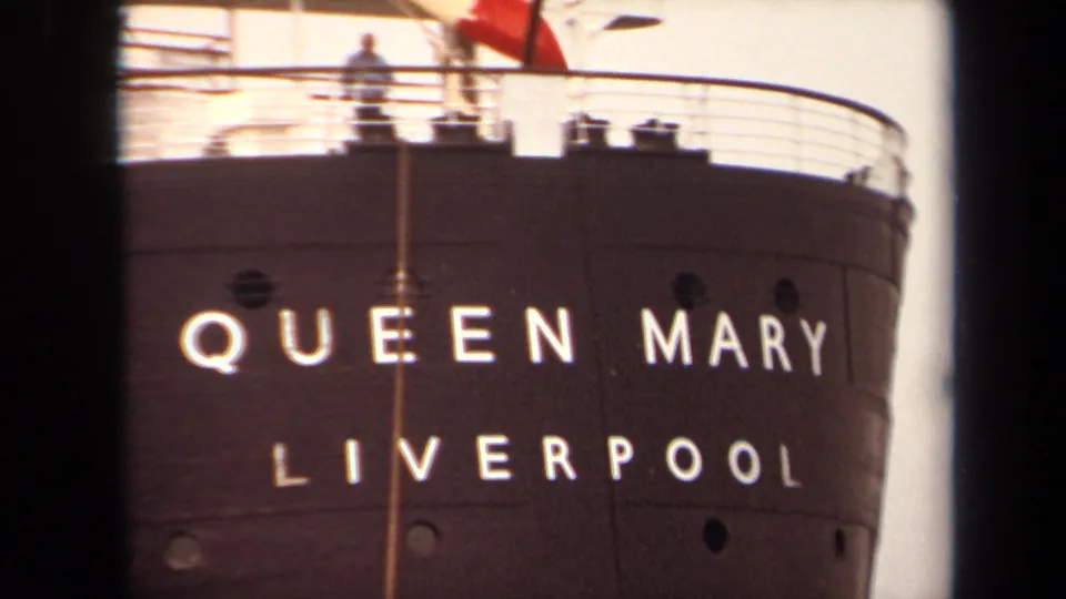 1971 Long Beach 8mm frame with the Queen Mary and Liverpool lettering centered on the dark hull, plus portholes and deck rail above.